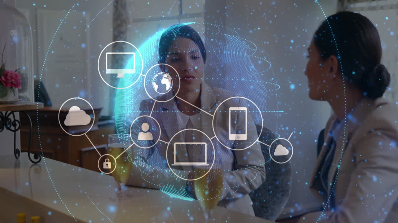 Discussing technology, businesswomen with digital network icons in office setting