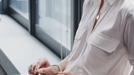 Millennial-blonde-white-woman-using-a-laptop-computer-on-her-knee,-side-view,-handheld-tilt-shot