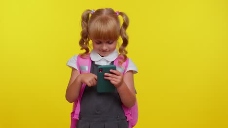 Girl-kid-in-school-uniform-using-mobile-phone-typing-new-post,-sms-message,-browsing-social-networks