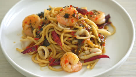 spicy spaghetti seafood - stir fried spaghetti with shrimps, squid and chilli