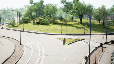 asphalt road and green trees in park