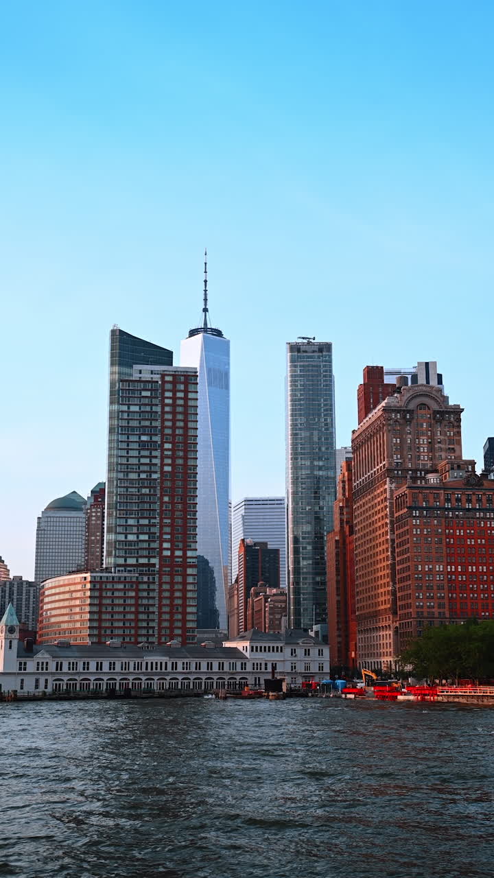 Viaggio fluviale nei dintorni di New York, USA. Vista dal basso angolo del bellissimo edificio nello skyline sul lungofiume. Video verticale