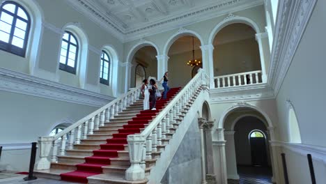 elegant interior staircase with people