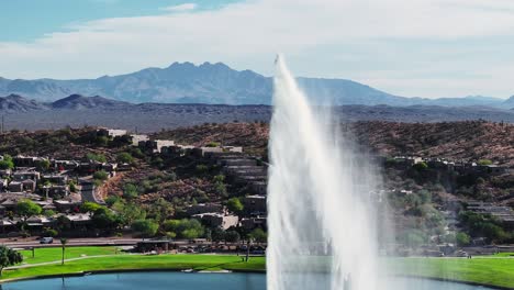 Water-falls-down-onto-lake-after-being-pushed-up-into-air-from-Fountain-Hills,-Arizona