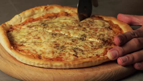 cutting a fresh, cheesy pizza with a pizza cutter, showing the crispy crust and melted cheese. perfect for illustrating homemade pizza preparation and italian comfort food.