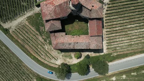 rising top down drone shot over italy's castello di la volta on a sunny day