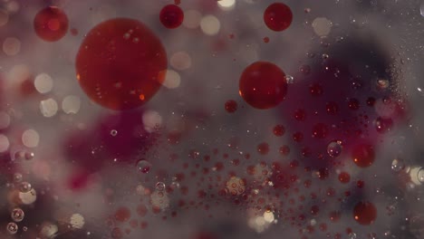 abstract burbujas líquidas claras y salpicaduras rojas de sangre movimiento bokeh movimiento textura de fondo