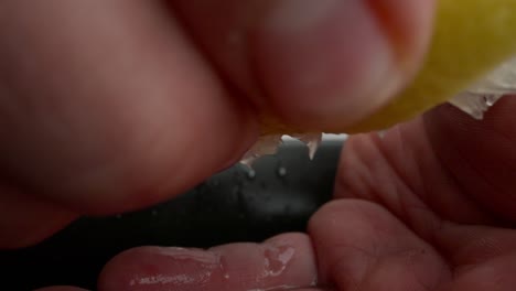 chef drains a lemon to prepare cebiche