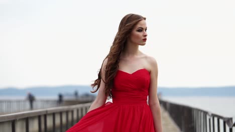Woman in a Red Dress on a Pier