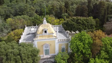 aerial circular orbit flying over beautiful palace in historical park in downtown lisbon, portugal