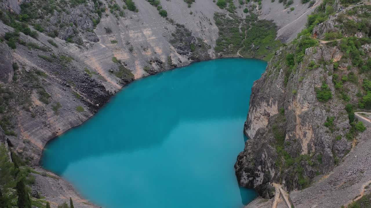 Fantastic hidden sinkhole karst red lake in Imotski Croatia aerial