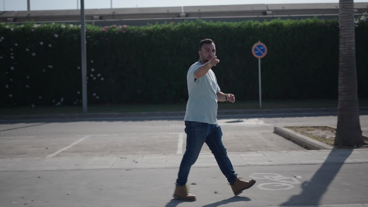 Man Walking in Parking Lot