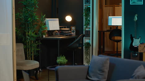 Contemporary studio with modern decorations and neon lights creating a cozy casual living space with a smart tv and comfortable setup. Empty apartment loft with trendy furniture.