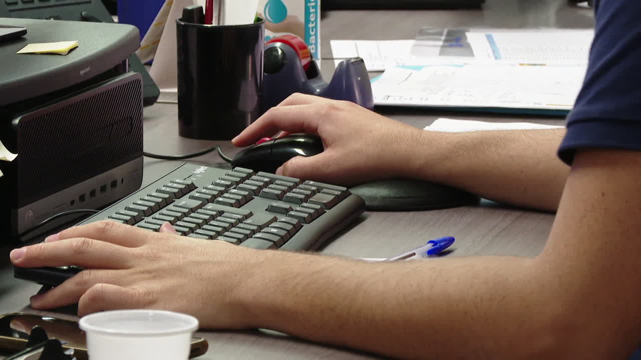 persona que trabaja en una computadora en un escritorio