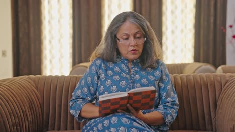 Curious-Indian-old-woman-reading-a-book