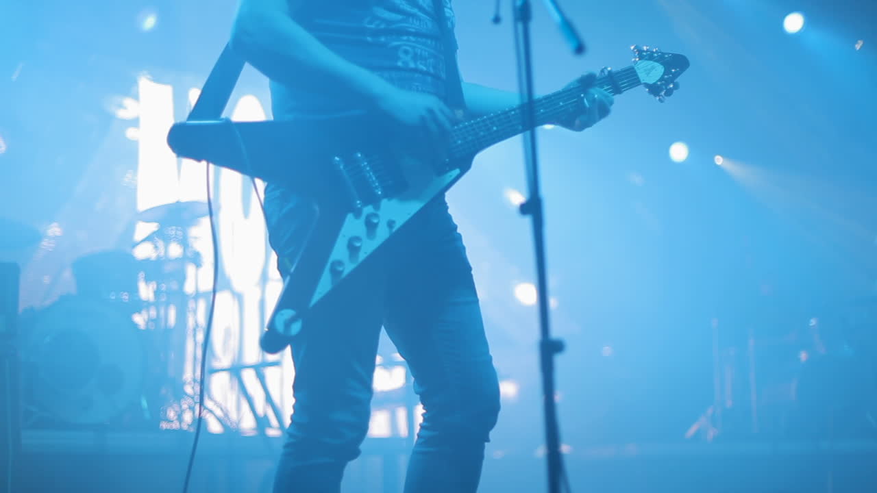 Musician performing with electric guitar on stage in a concert