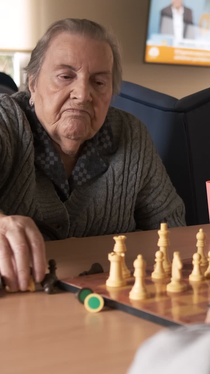 Senior people playing board game in retirement home