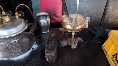 pouring, prepared tandoori milk tea or chai with tea stainer. selective focus is used. footage of tandoori tea or chai