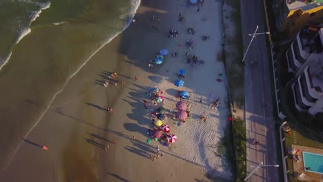 Aerial-tilt-up-shot-revealing-Bombas-beach-and-town-at-golden-hour-in-Brazil