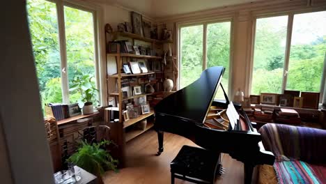 cozy living room with piano and bookshelves