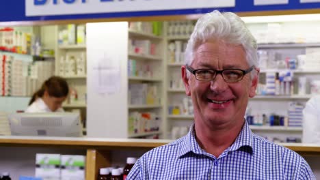 customer holding prescription while checking medicine in pharmacy