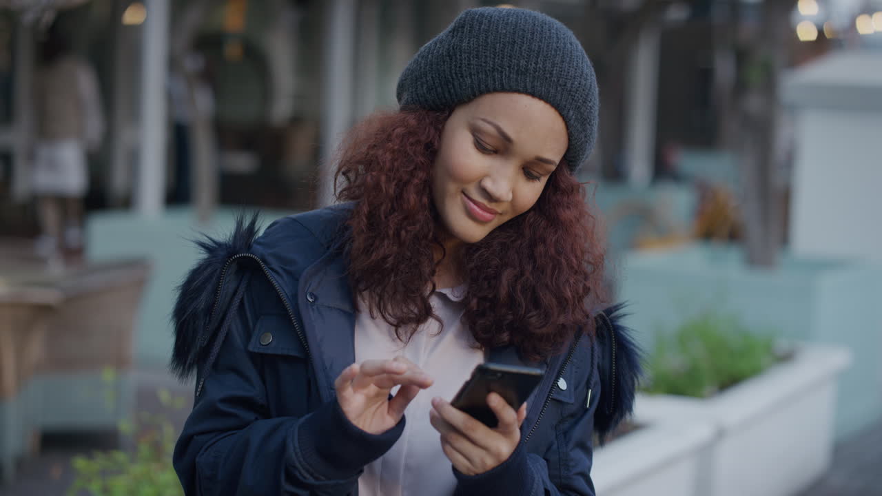 portrait beautiful young woman using smartphone texting browsing messages smiling enjoying mobile phone communication in city wearing warm stylish fashion