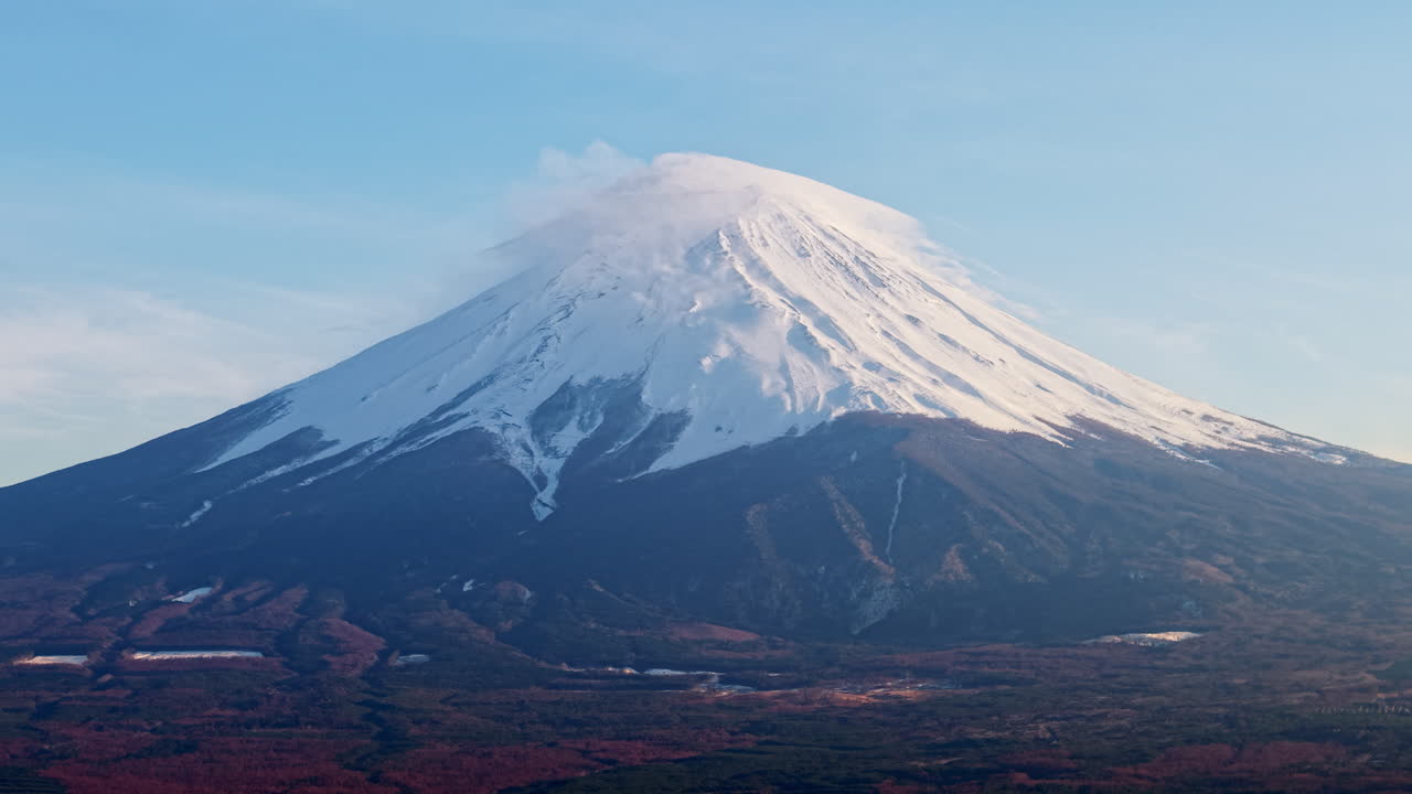 Aerial drone view of Mount Fuji with snow at the top in daylight
