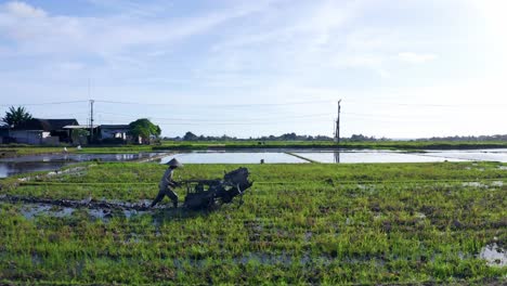 farmer with plowing tractor working on farmland