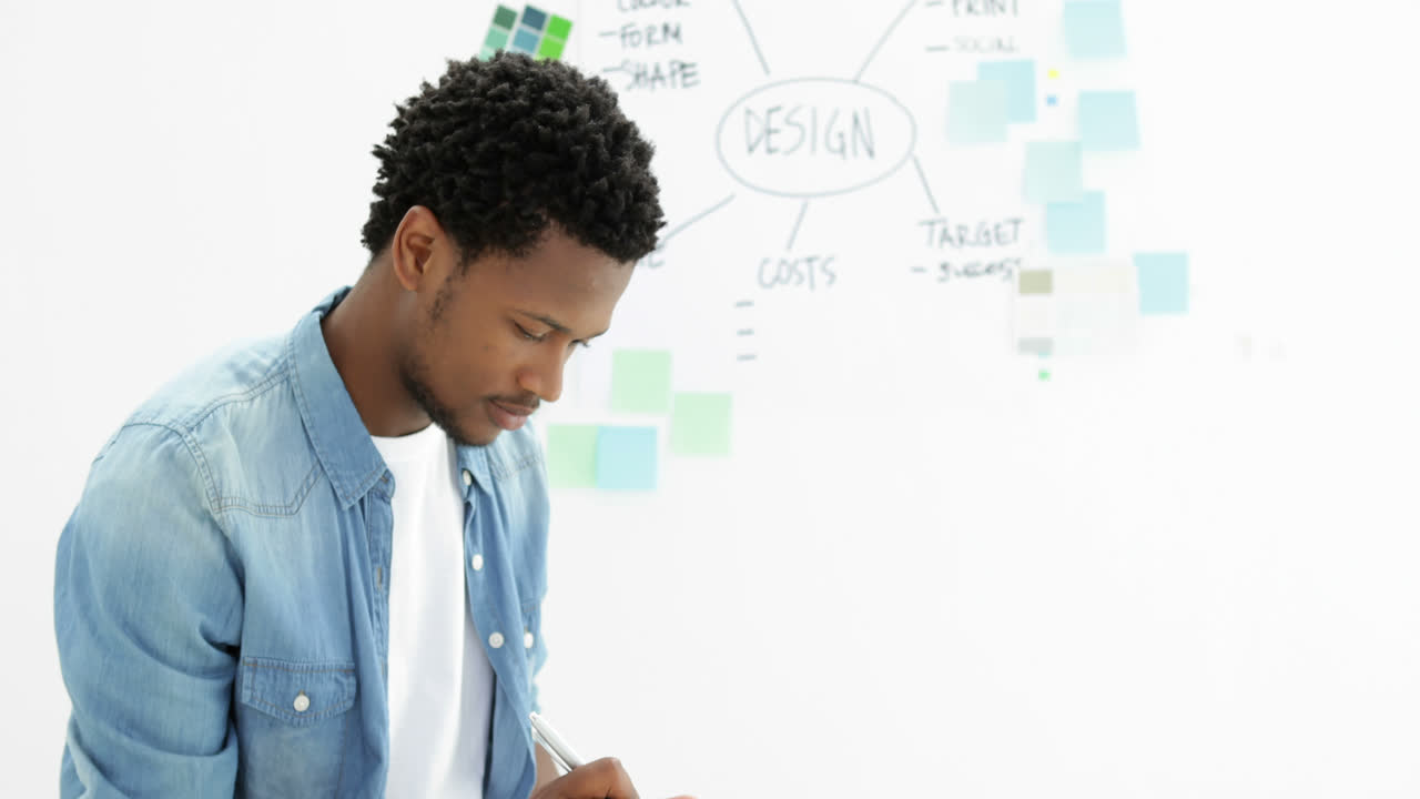 Focused creative designer working on his tablet 