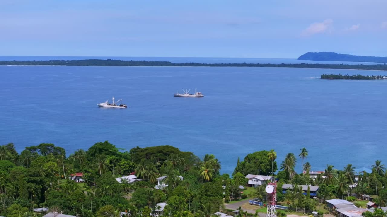 Wewak Port container ship cargo vessels boat Dogreto Bay Wewak Hill aerial drone East Sepik Region Province Papua New Guinea summer dry season clear skies Boram Hospital circle left motion
