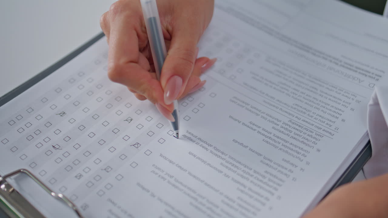 Hands examining medical checklist in polyclinic office closeup. Unknown doctor