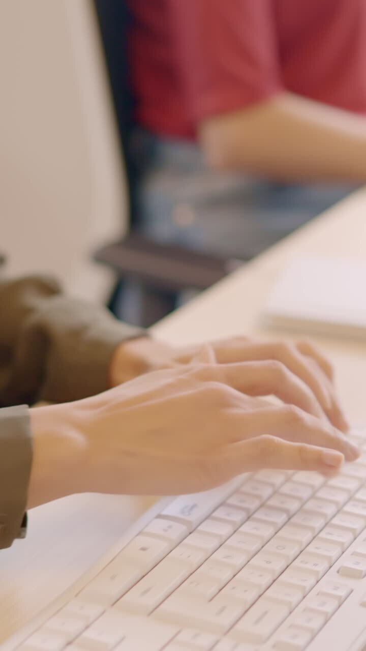 Young woman using keyboard in a coworking