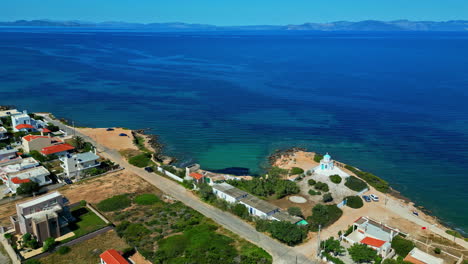 aerial view of a greek island coastline with houses on a sunny and hot day