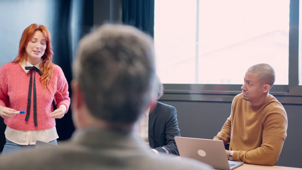Woman clarifying an idea during a presentation in a meeting
