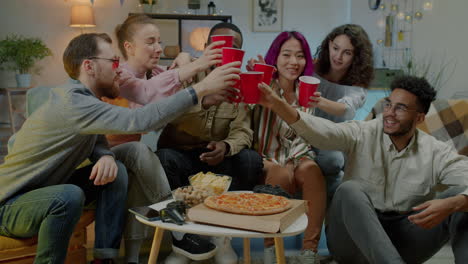 Friends Toasting with Pizza and Drinks