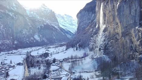 moving towards waterfall over village | lauterbrunnen switzerland, swiss valley in alps drone, europe, 4k