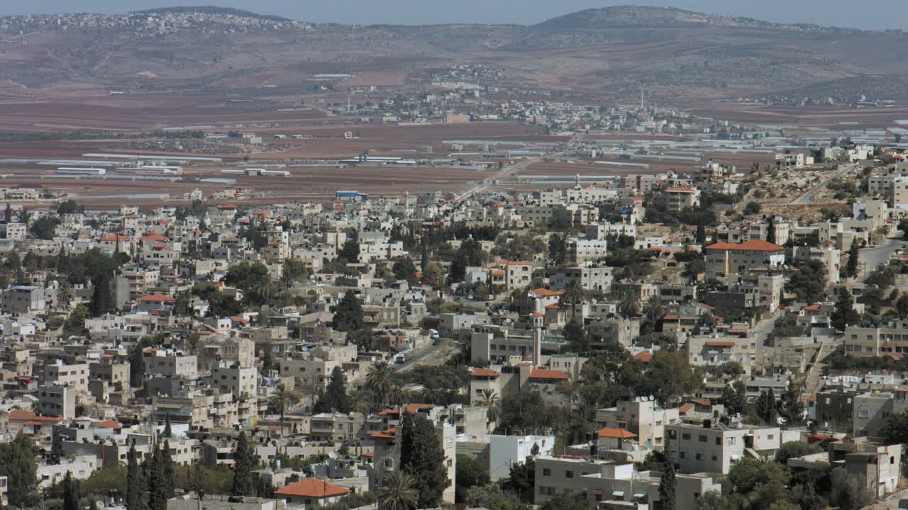 Jenin, Palestine, West Bank, long shot, Jenin houses, buildings with Jezreel Valley, Marj Ibn Amer in northern west bank. 4K footage