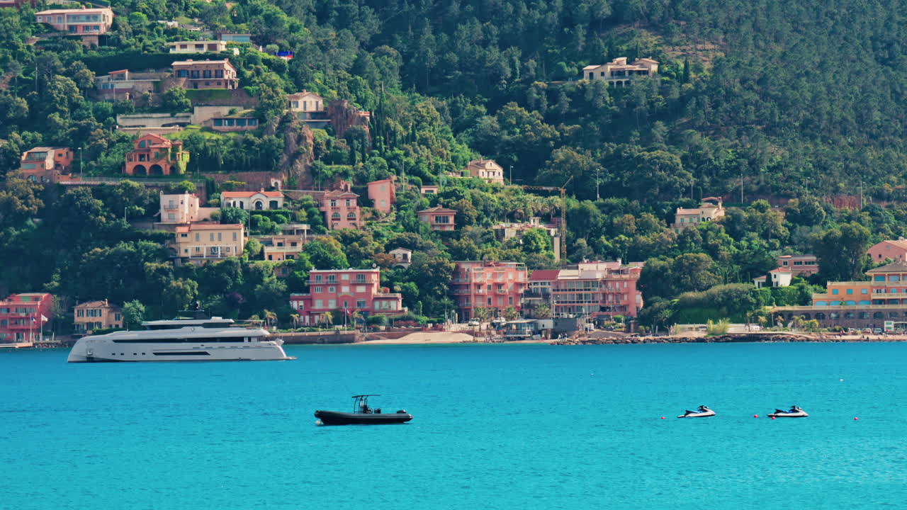 Boats docked on the Mediterranean Sea with the villas in Mandelieu-La Napoule, France on the background