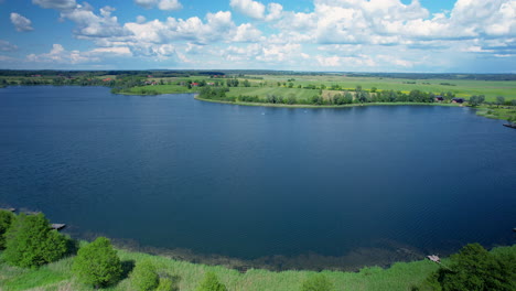 Landscape-over-blue-wielochowskie-lake,-summer,-aerial-drone,-beauty