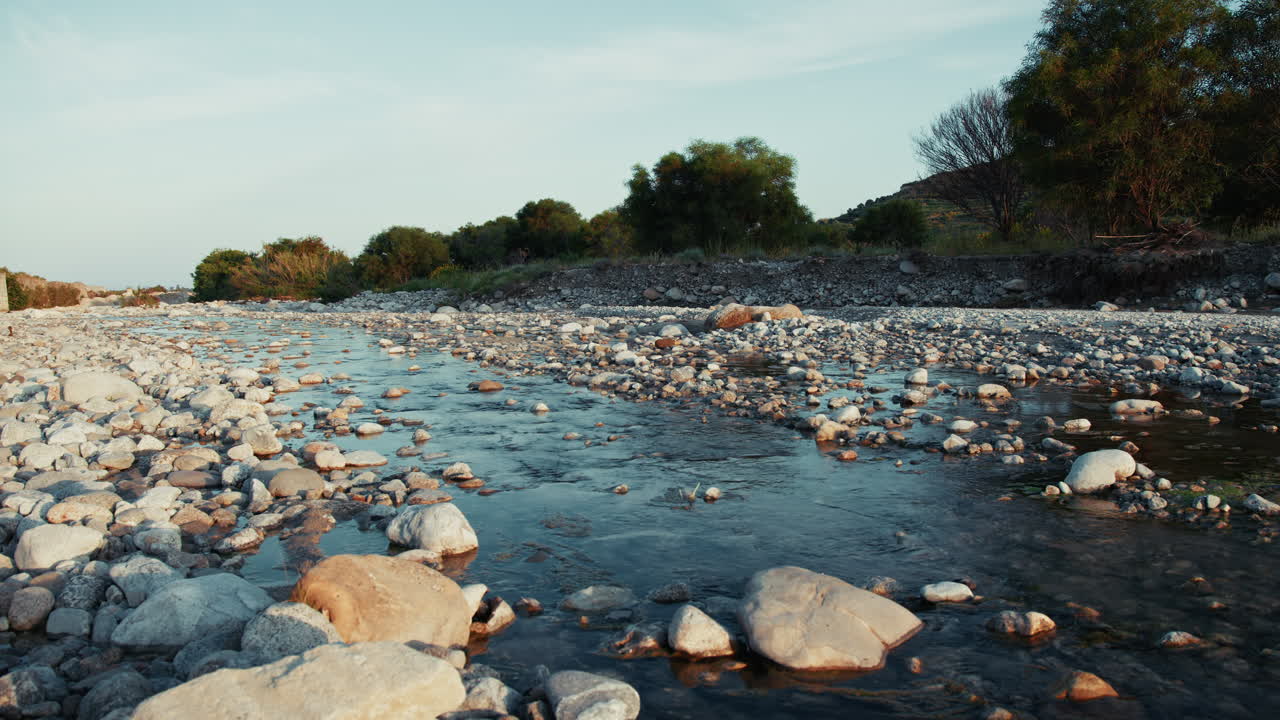 River Flowing Between Rocks In Religious Natural Landscape At Sunset