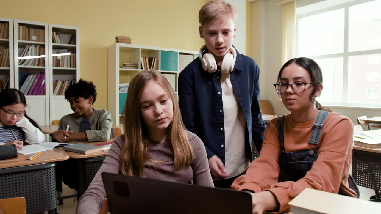 Students collaborating on a laptop in a classroom