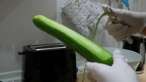 A-cucumber-is-peeled-with-a-potato-peeler