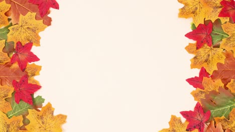 autumn leaves ordering on left and right side of beige background. stop motion