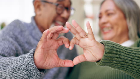 Heart,-hands-and-couple-in-home-for-love