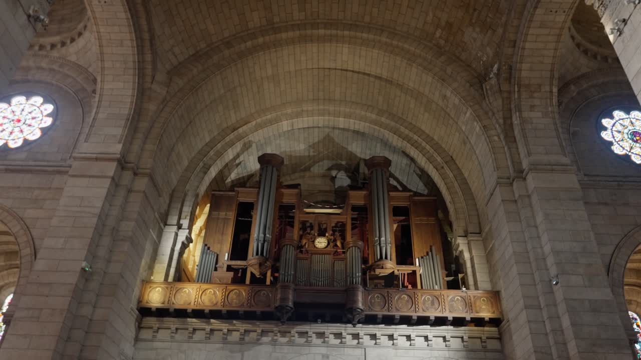 Long view wide angle of The old organ piano in the church of The Basilica of the Sacred Heart of Paris.
