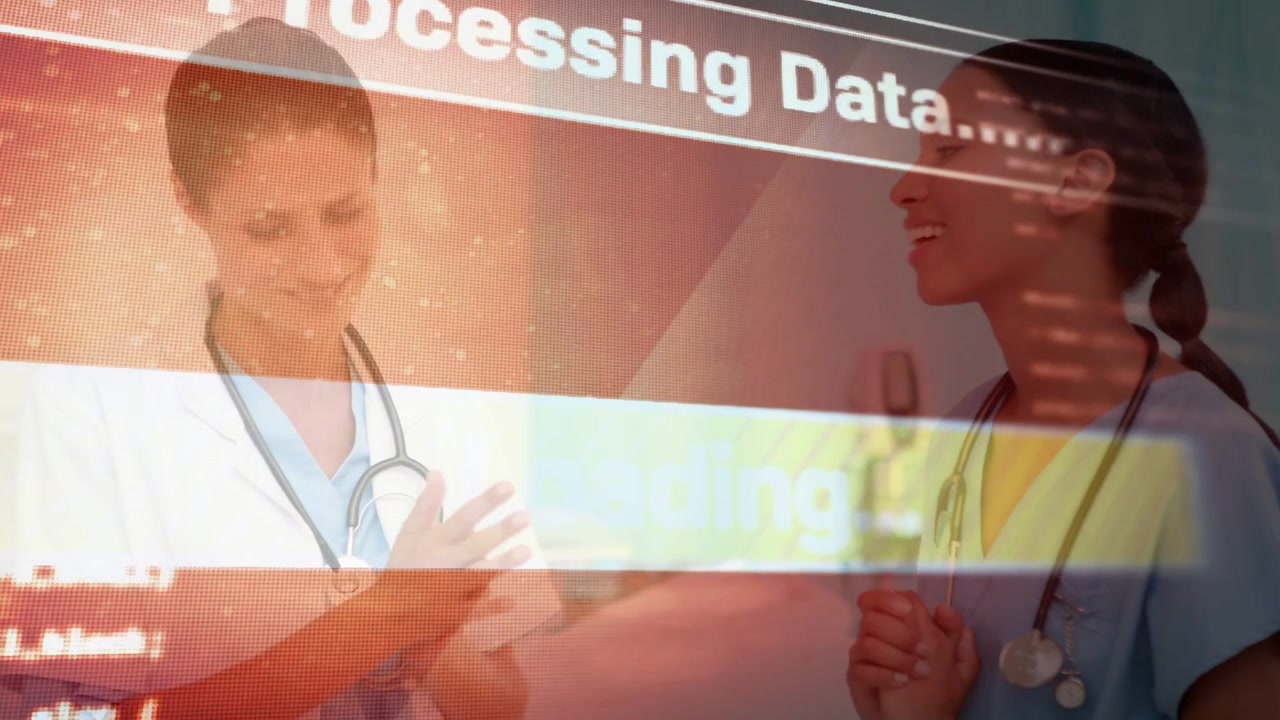 Two female clinicians gesturing and smiling in ward as loading overlay processing patient data
