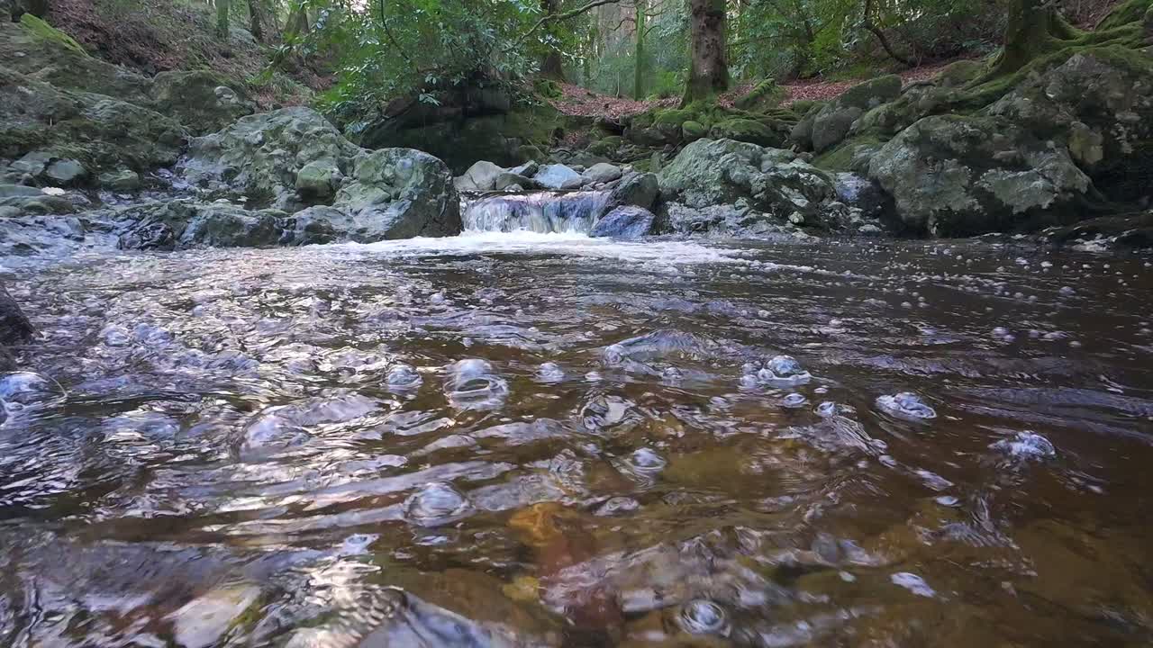 mountain stream cascade in pool and bubbles floating by Mahon River Comeragh Mountains Waterford Ireland