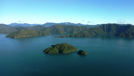 establishing aerial flyover above small island in queen charlotte sound, part of the marlborough sounds in south island, new zealand