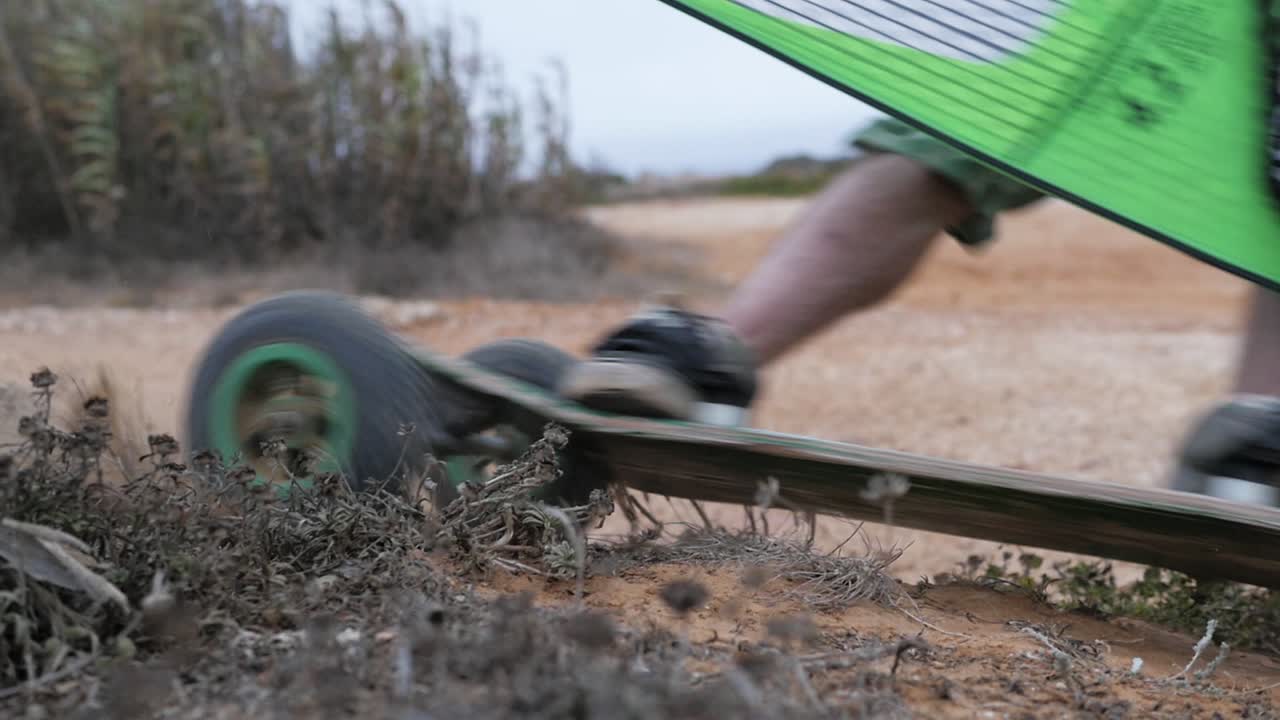 Slow motion of Portuguese windsurfer trying out his sail on a skate and going super fast, close shot on a drift
