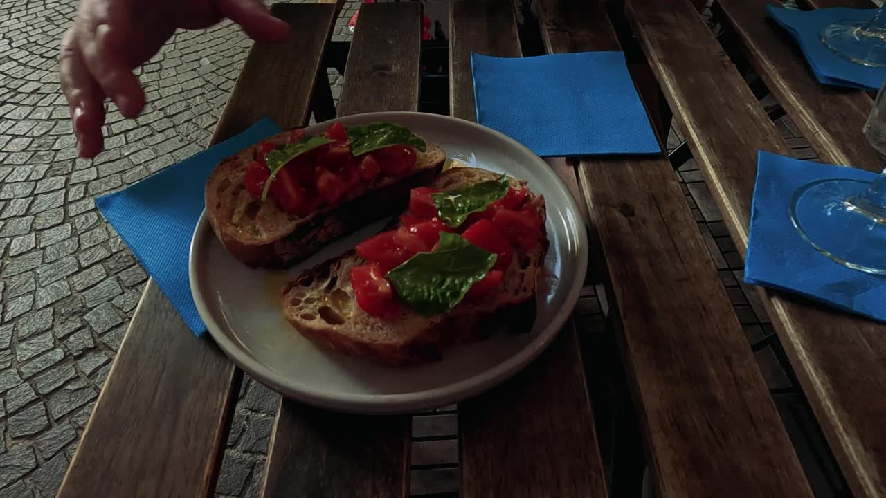 Savoring tomato basil bruschetta at an outdoor cafe